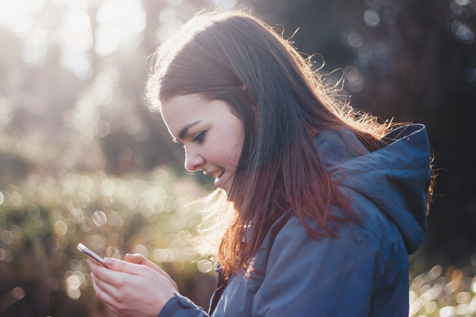 Como Fazer Planilha Financeira em 20 Minutos do Zero Mulher sorrindo ao registrar gastos pelo celular sem precisar de planilha financeira